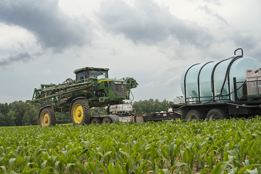 Sprayer in an early-season corn field