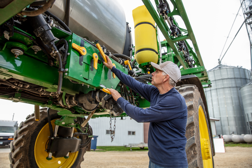 Grower adjusting parts on sprayer