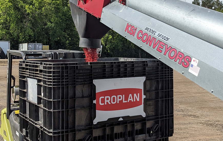 Treated soybean seed being loaded into a CROPLAN® seed box. 